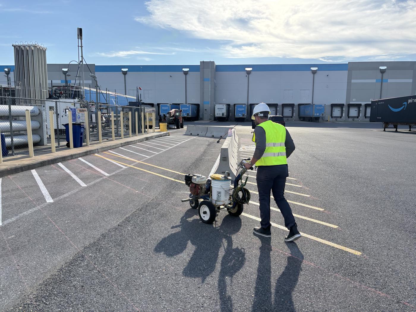 Louisiana Striping & Pavement running a Graco line striper in the truck court of a distribution center in Carencro, Louisiana