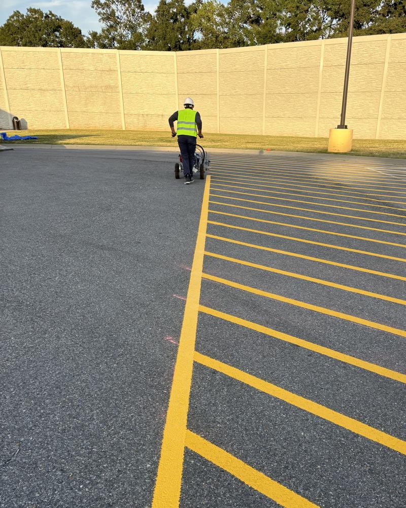 Yellow crosshatch pavement markings at an Amazon distribution center in Carencro, LA